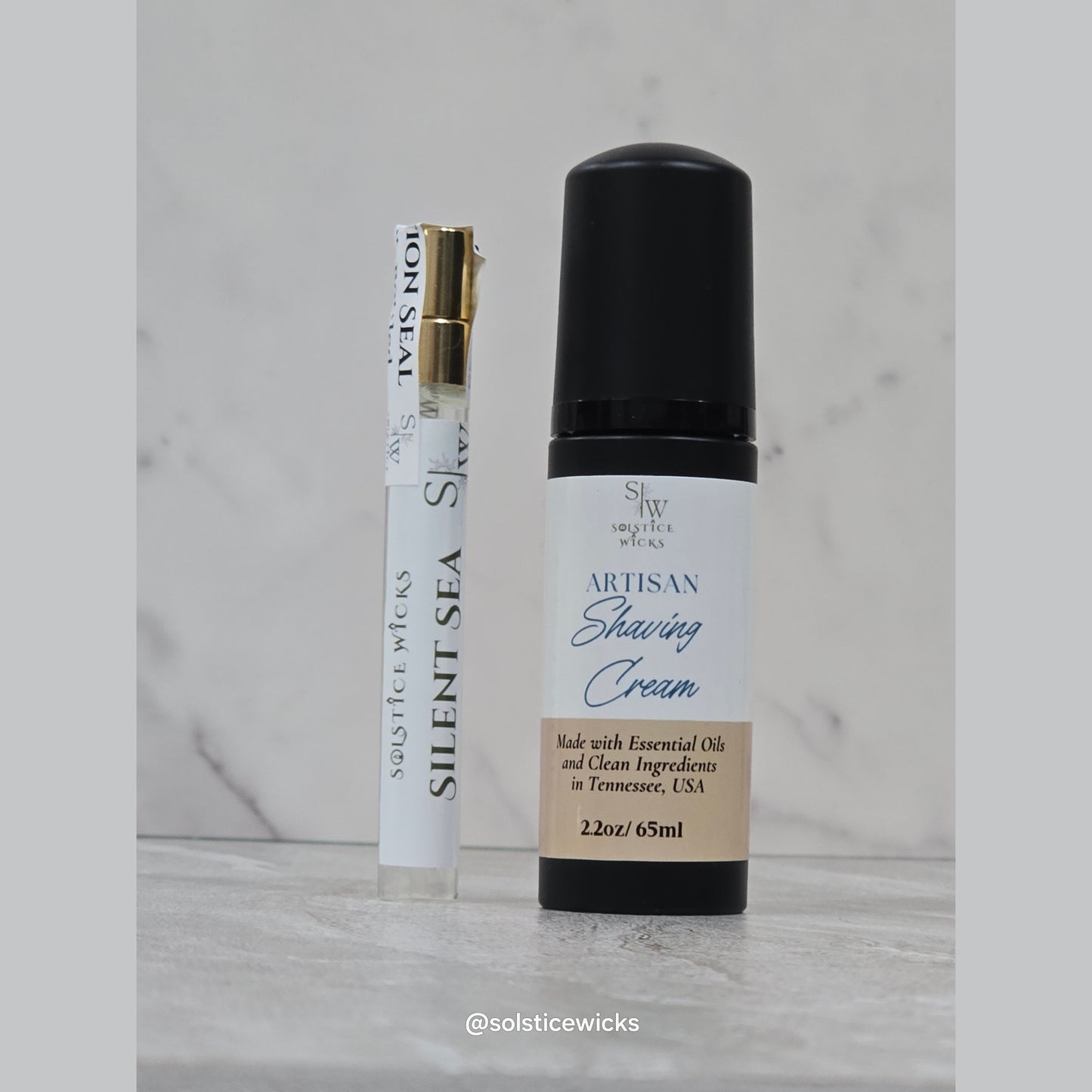 To-go parfum clear bottle with a shaving cream black bottle 