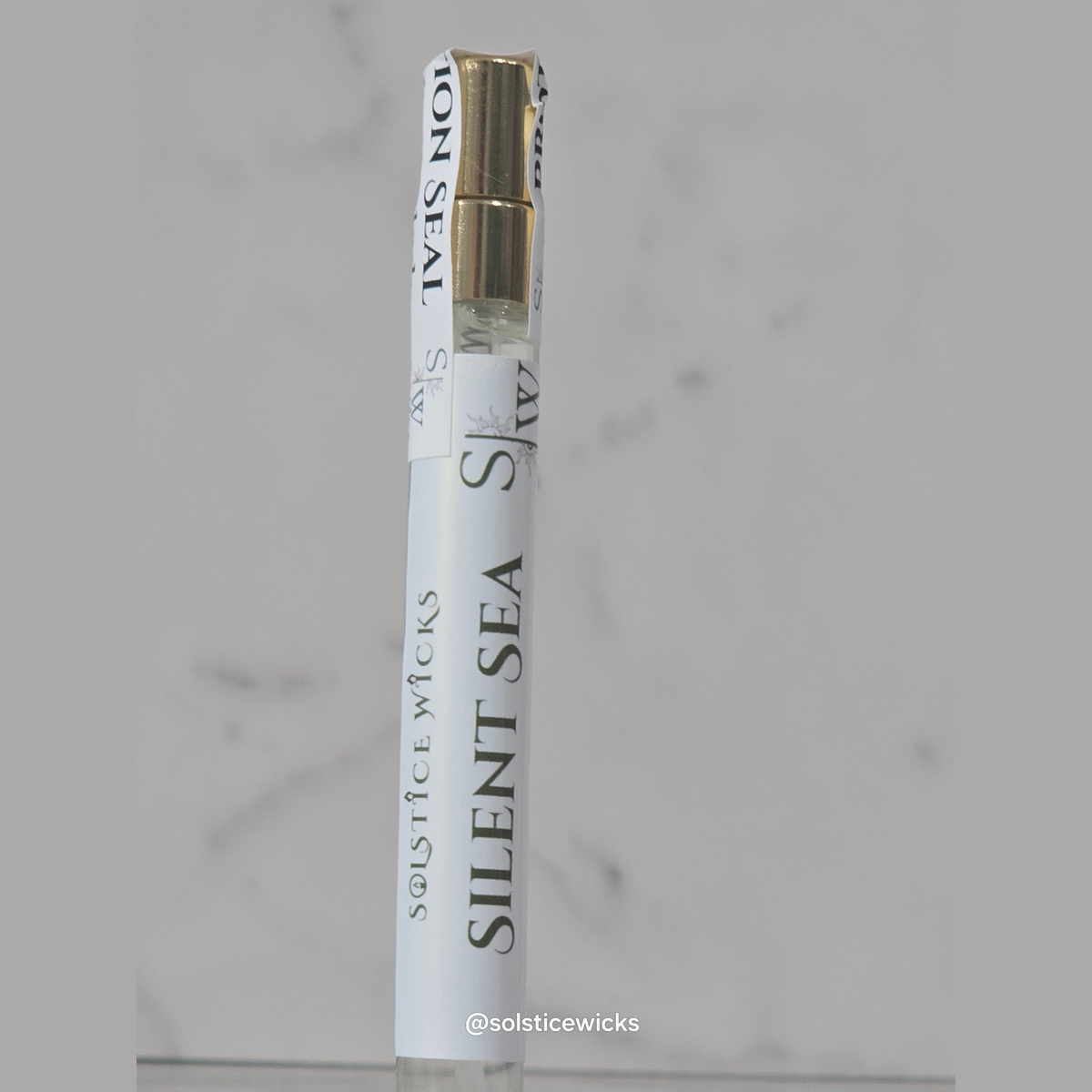 Perfume To-Go with 'Silent Sea' name made by solstice wicks on a gray background