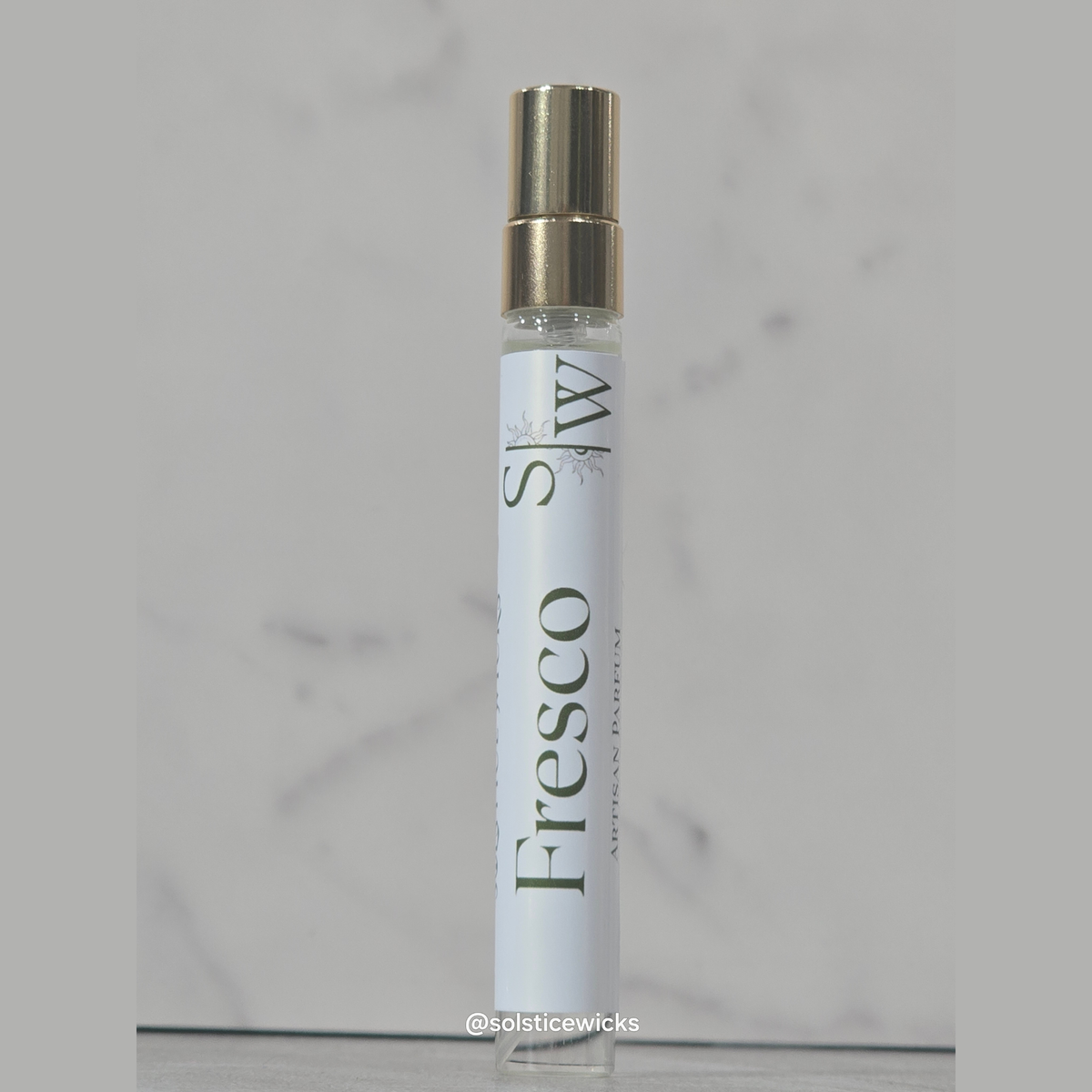 To-go spray Crystal bottle with a white label with the name Fresco on it, on a grey background