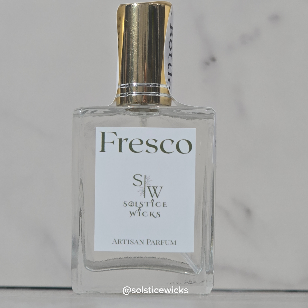 30ml spray Crystal bottle with a white label with the name Fresco on it, on a grey background