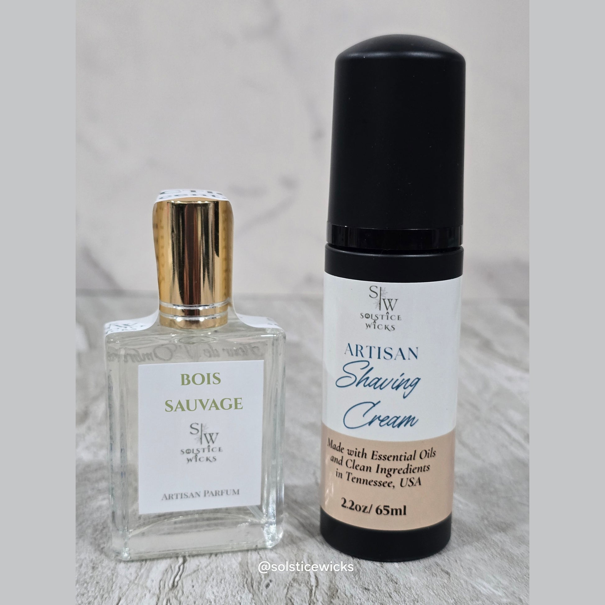 small parfum in clear bottle nest to shaving cream black bottle